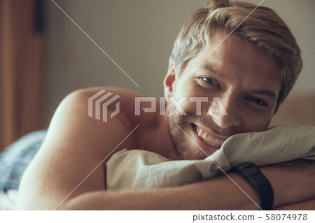 Young man being cheerful after waking up Young man being cheerful after waking up 58074978