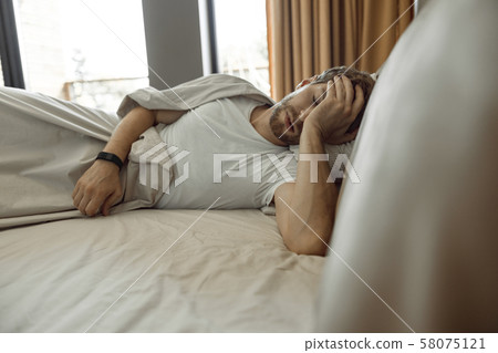 Tired man being wiped out in the morning 58075121