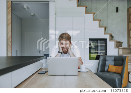 Smiling man recieving messages from his girlfriend 58075828