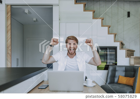 Man being extremely happy in the end of working day 58075829