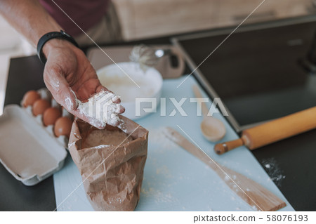 Cook perfecting the dish he cooking in the kitchen 58076193