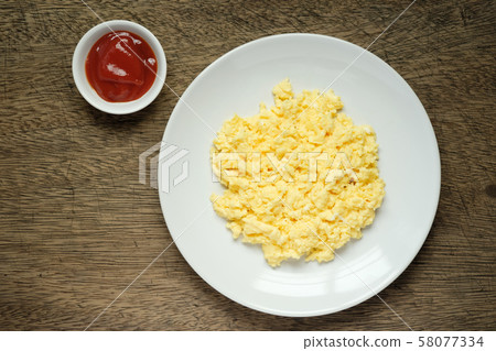 Scramble on a white plate with copy space,ketchup Scramble on a white plate with copy space,ketchup 58077334