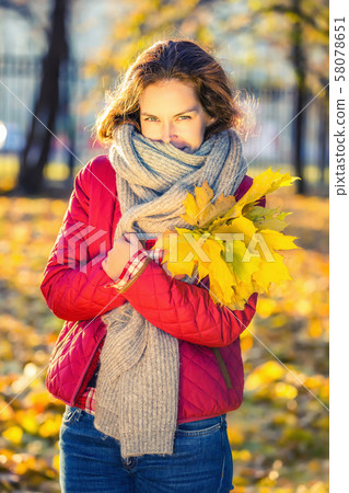 Happy young woman in autumn park Happy young woman in autumn park 58078651