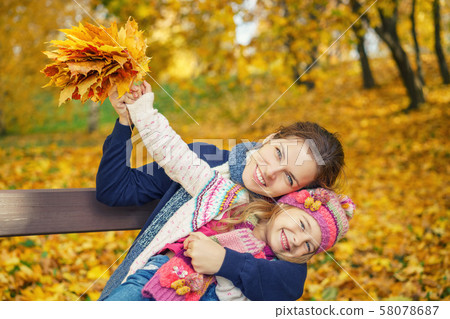 Mother and daughter in the autumn park Mother and daughter in the autumn park 58078687