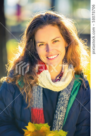 Portrait of young beautiful woman in autumn park 58078706