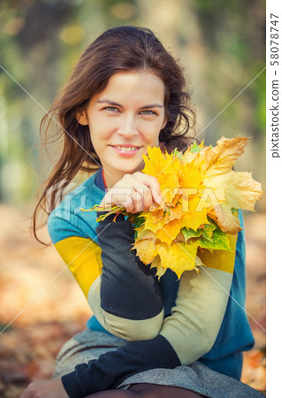 Portrait of young beautiful woman in autumn park 58078747