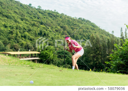 Asian woman golfer action to win  58079036