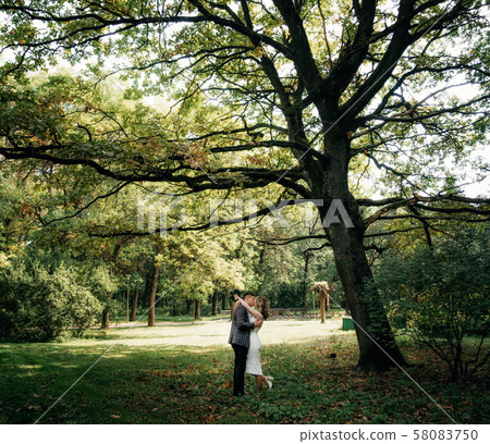 Portrait of kissing couple in the garden. Portrait of kissing couple in the garden. 58083750