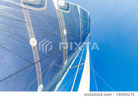 Sail of a Catamaran sailing boat against clear 58084235