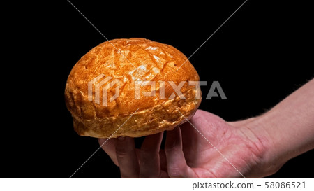 Air bun for craft burger is cooking on black background. Not made ideal. Looks real. Loving hand Air bun for craft burger is cooking on black background. Not made ideal. Looks real. Loving hand 58086521