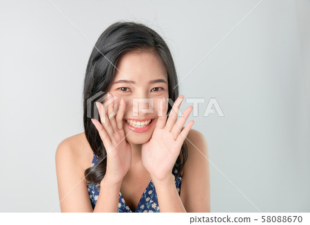 Attractive young asian woman announcing with hands Attractive young asian woman announcing with hands 58088670