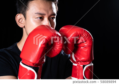 Men wearing boxing gloves Men wearing boxing gloves 58089894