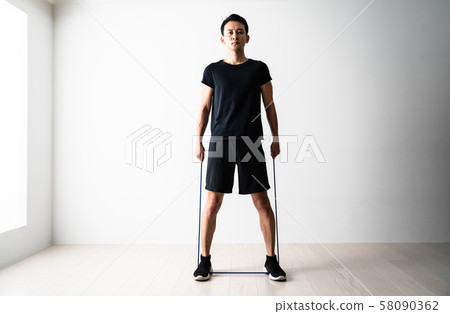 Sportsman doing tube training 58090362