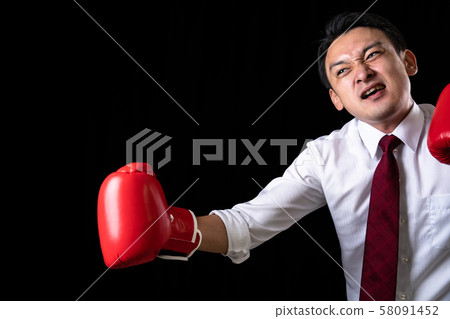 Businessman taking a fighting pose Businessman taking a fighting pose 58091452