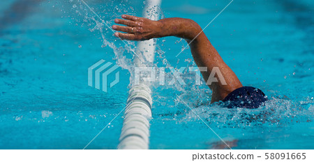 Swim competition swimmer athlete doing crawl stroke in swimming pool Swim competition swimmer athlete doing crawl stroke in swimming pool 58091665