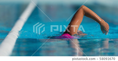Swim competition swimmer athlete doing crawl stroke in swimming pool Swim competition swimmer athlete doing crawl stroke in swimming pool 58091670