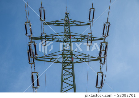 High voltage power lines through fields and meadows they supply power to towns and villages High voltage power lines through fields and meadows they supply power to towns and villages 58092701