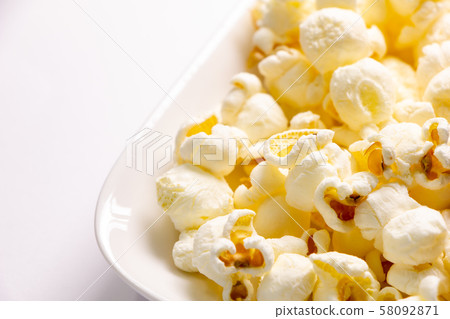 Popcorn up. (White plate, white background) Popcorn up. (White plate, white background) 58092871