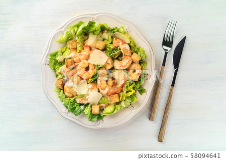 Shrimp Caesar salad with Parmesan cheese, croutons and lettuce, shot from above Shrimp Caesar salad with Parmesan cheese, croutons and lettuce, shot from above 58094641