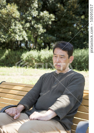 A retired middle-aged man with one person down in Yoyogi Park 58095057