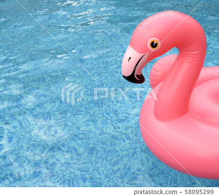 Inflatable pink flamingo float in bright blue pool Inflatable pink flamingo float in bright blue pool 58095299