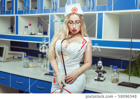 Erotic nurse with a stethoscope in her hands. 58096348