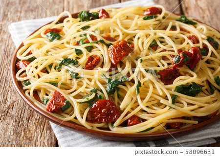 Traditional spaghetti with dried tomatoes, cheese 58096631