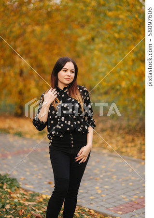 Beautiful woman in the park in autumn. Happy female Beautiful woman in the park in autumn. Happy female 58097606