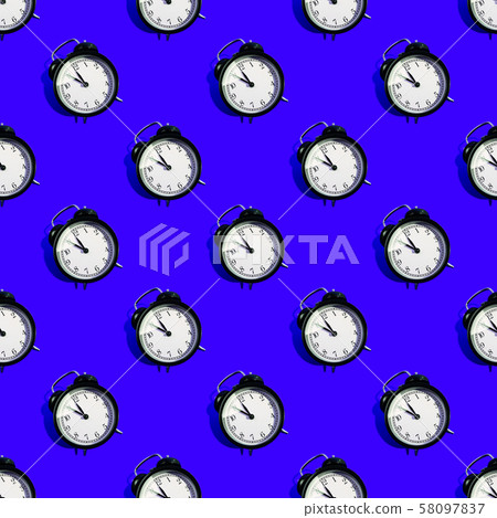 Many black classic style alarm clock isolated on blue background Many black classic style alarm clock isolated on blue background 58097837