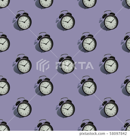 Many black classic style alarm clock isolated on purple background Many black classic style alarm clock isolated on purple background 58097842