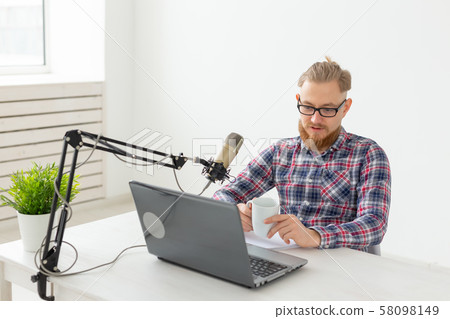 Radio host, streamer and blogger concept - Handsome man working as radio host at radio station 58098149