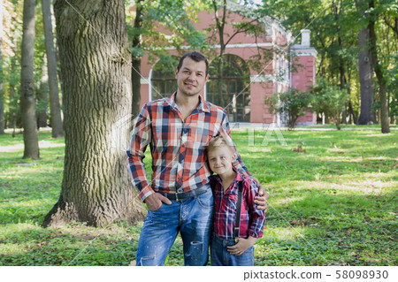 Beautiful dad and son are walking in the park. 58098930