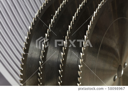Segment of circular saws for cutting wood closeup. 58098967
