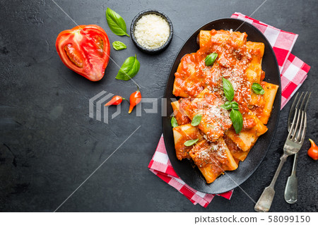 Pasta paccheri with tomato sauce 58099150