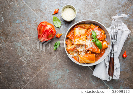 Pasta paccheri with tomato sauce 58099153