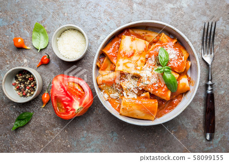 Pasta paccheri with tomato sauce 58099155