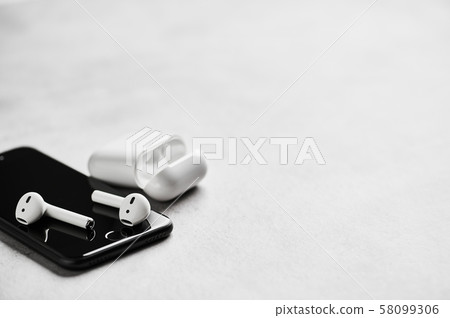 Wireless earphones with case and smartphone. Wireless earphones with case and smartphone. 58099306