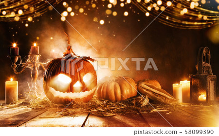 Spooky halloween pumpkin on wooden planks in dark Spooky halloween pumpkin on wooden planks in dark 58099390