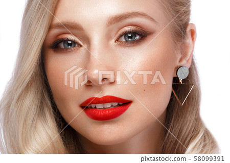 Beautiful blonde in a Hollywood manner with curls, natural makeup and red lips. Beauty face and hair Beautiful blonde in a Hollywood manner with curls, natural makeup and red lips. Beauty face and hair 58099391