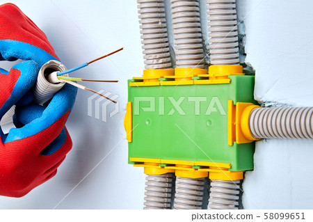 Electrician installed a hidden junction box. Electrician installed a hidden junction box. 58099651
