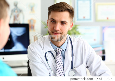 Smiling doctor talking with colleague Smiling doctor talking with colleague 58100892