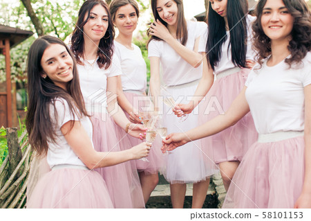 Girls at bachelorette party with champagne glasses 58101153