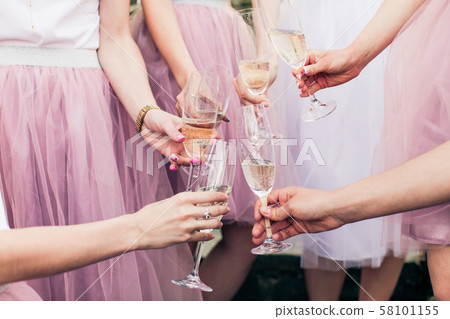 Close view of hands with glasses of champagne Close view of hands with glasses of champagne 58101155