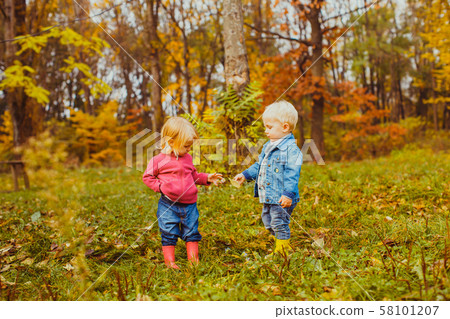 Cute kids walking in the autumn park 58101207