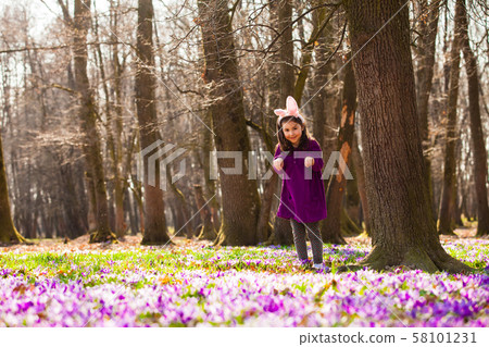 Little girl with banny ears in spring park 58101231