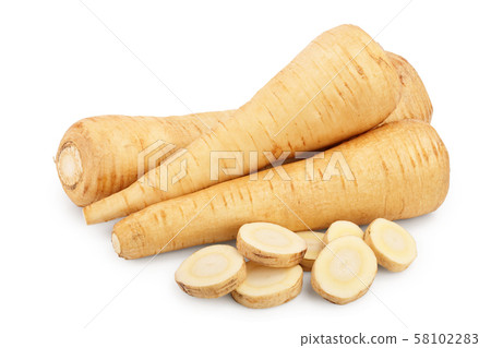 Parsnip root and slices isolated on white background closeup 58102283