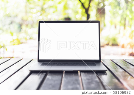 Blank screen laptop computer on wood table. Blank screen laptop computer on wood table. 58106982