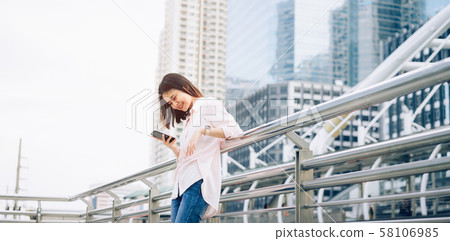Beautiful Asian woman using smartphone. Beautiful Asian woman using smartphone. 58106985
