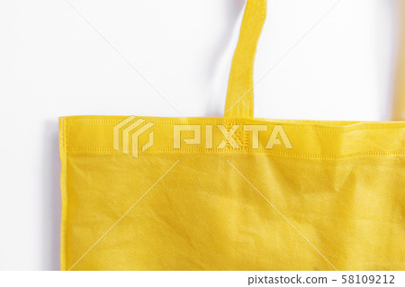 Close-up, Yellow reusable fabric bag, on white background 58109212