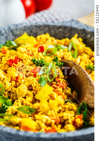 Tofu scramble with vegetables in a pan. Tofu scramble with vegetables in a pan. 58110445